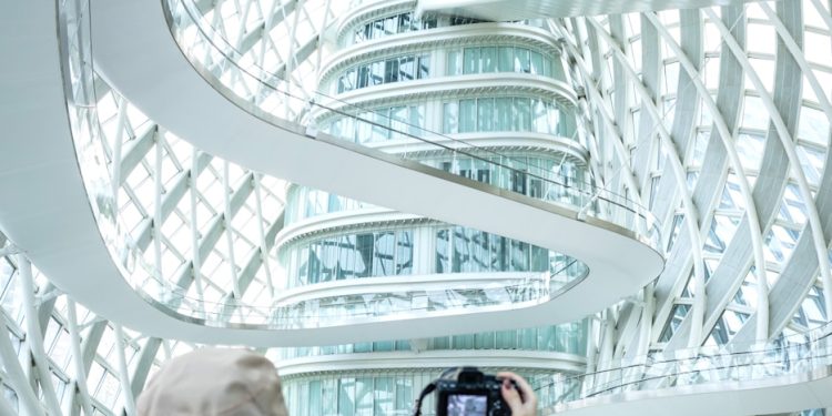 a woman taking a picture of a building with a camera